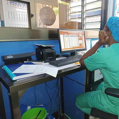 Black patient and doctor with face masks doing medical checkup in cabinet. African american medic doing healthcare consultation with person while protecting against coronavirus pandemic